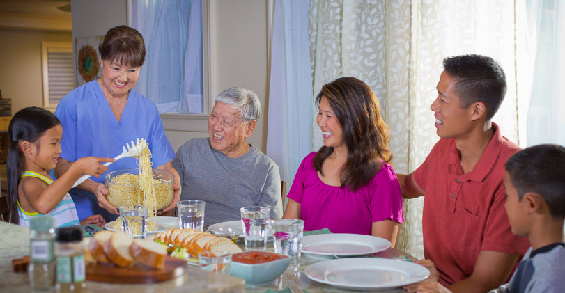 Hawaii senior aging in place with help of home caregiver family dinner