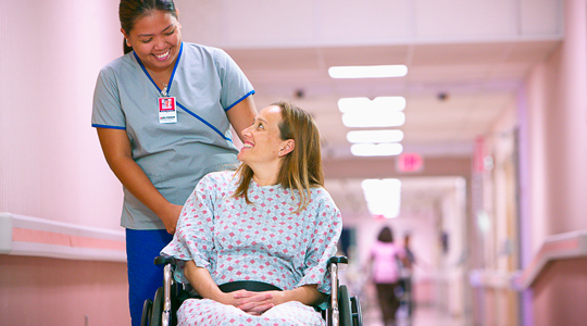 patient in wheelchair at hospital with nurse